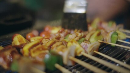 Wall Mural - Asian people having a barbecue party and drinking beer.