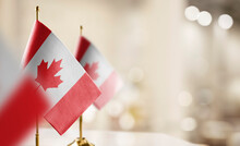 Small Flags Of The Canada On An Abstract Blurry Background