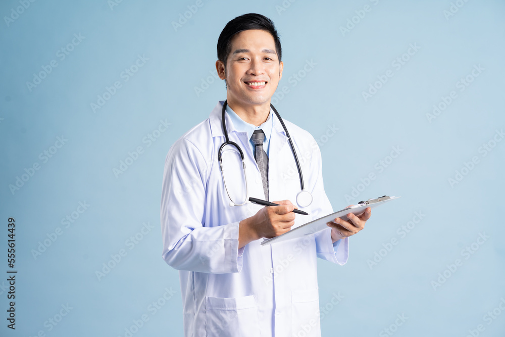 Asian male doctor portrait on blue background Stock Photo | Adobe Stock