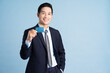© Q88 - portrait of asian businessman wearing suit on blue background