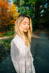 Wall Mural - Portrait of attractive caucasian woman posing in the autumn park.