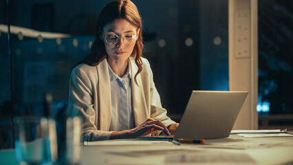 Aufkleber - Stylish Female Working on Laptop Computer in a Company Office in the Evening. Young Manager Browsing Internet, Shopping Online and Reading Social Media Posts from Friends and Colleagues.