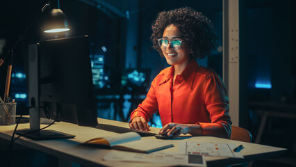 Poster - Beautiful Multiethnic Brazilian Female Working on Desktop Computer Late at Night. Young Creative Manager Having Fun in the Office, Chatting with Overseas Business Partners, Answering Emails.