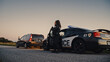 © Gorodenkoff - Black Female Police Officer Stepping Out of Patrol Car and Heading Towards a Pulled over Car. Cops Responding to a 911 Call About a Suspicious Car Stopped on the Road, Investigating the Situation