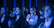 Audience Full of Business People Clapping in Dark Conference Hall During an Inspiring Keynote Presentation. Business Technology Summit Auditorium Room Full of Delegates.