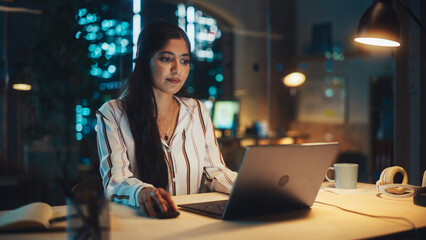 Poster - Young Diverse Accountant Working in the Office Late in the Evening. Positive Female Using Laptop Computer, Preparing Job Assignment and Corporate Report for Finance Director.
