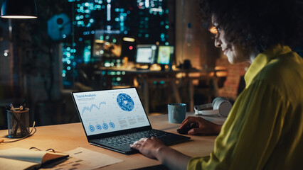 Aufkleber - Creative Multiethnic Female Working on Laptop Computer with a Sales Statistics and Chart Displayed on Screen. Successful Designer Developing a Marketing Strategy, Preparing a Presentation