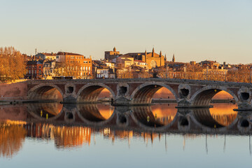 Wall Mural - Scenic autumn sunset view of the Pont Neuf or New Bridge on the Garonne river in the famous pink city of Toulouse, France