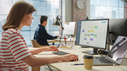 Aufkleber - Portrait of Caucasian Creative Young Woman Working on a Calender Software on a Desktop Computer in Bright Busy Office. Female Team Lead Smiling Happily While Checking Team Events for the Month.