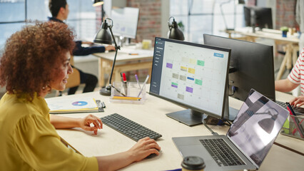 Poster - Portrait of a Young Biracial Woman Using Computer in a Busy Executive Assistant Working on Scheduling Meetings.