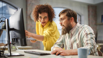 Poster - Portrait of Two Creative Colleagues Collaborating and Pointing at the Computer in Modern Office. Biracial Female Manager Consults Male Projects Manager, They Brainstorm on the Project.