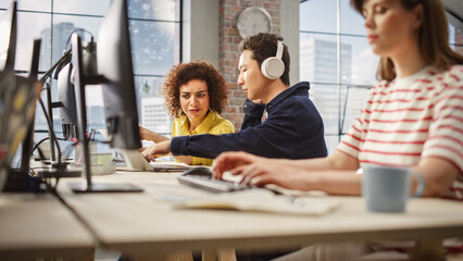 Leinwandbilder - Group of Colleagues Working On Computers in Office. Female Biracial Help Desk Coordinator Collaborates with Asian Male Customer Service Agent with headophones,