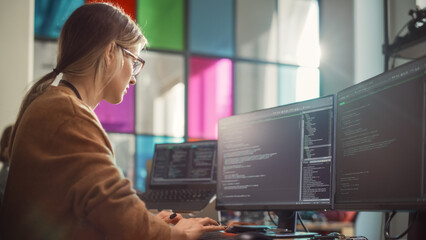 Fototapete - Female Software Engineer Writing Lines of Code on Professional Multiple Display PC Setup In Stylish Office. Caucasian Woman Fixing Bugs and Creating New Features For Innovative Digital Service.