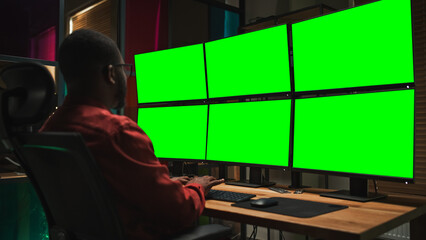 Poster - Black Cyber Security Specialist Coding on Desktop Computer With Six Monitors With Green Screen Chromakey. African American Male Contractor Monitoring Data Protection System For Private Sector.