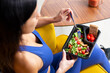 Fit woman eating healthy food at home.