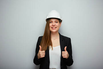 Business woman architect or engineer in white helmet showing thumbs up. Isolated female portrait.