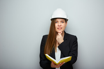 Thinking woman student or teacher architect engineer profession holding book.