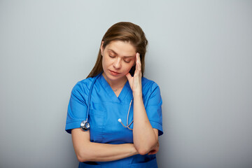 Wall Mural - Thinking doctor or nurse in medical suit. Isolated portrait.