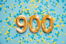 900 Nine Hundred Followers Subscriber Card. Golden Birthday Candle On Yellow And Blue Confetti Festive Background. Template For Social Networks, Blogs. Media Celebration Banner. Online Community Fans