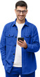 Smiling man wearing casual blue shirt looking at phone
