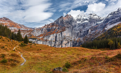 Fototapete - Scenic sunny landscape in mountains. Amazing nature landscape. Wonderful autumn scenery.  view no alpine highlands near Oeschinnensee lake. Switzerland. Europe. popular travel destination.