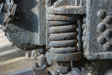 Close-up drive wheels and rods on steam engine locomotive. Vintage part of suspension of old train. Detailes rarity railway transport - lever and chassis, axle and connection. Parts rail.