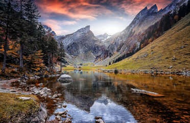 Fototapete - Colorful autumn landscape in the mountains. Lake Seealpsee near Appenzell in swiss Alps. Awesome alpine highlands in sunny day, Colorful sky Oner the Swiss Alps, Switzerland. Picture of a Wild Area.