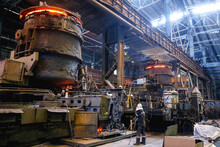 View From Inside The Shop Of A Steel Mill. Ladle Of Hot Metal At A Large Metallurgical Plant. Melting Pig Iron And Steel.