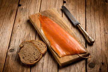 Poster - smoked salmon with sliced bread over cutting board