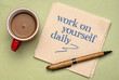 work on yourself daily - inspirational advice or reminder on a napkin with coffee, self improvement and personal development concept