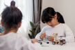 © FAMILY STOCK - Asia students learn at home in coding robot cars and electronic board cables in STEM, STEAM, mathematics engineering science technology computer code in robotics for kids concept.