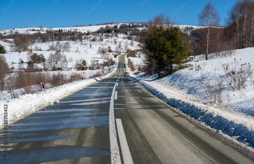 Amazing winter view with asphalt mountain road through a snowy forest ...