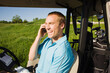© Designpics - Man Riding Golf Cart