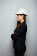 Profile portrait of woman engineer in white safety helmet. Isolated portrait.