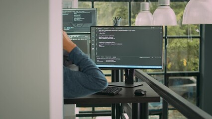 Asian system engineer working with html script on computer screen, using terminal window. Software developer coding system interface, writing innovating ai algorithm in office space.