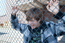 Angry Boy Behind Fence