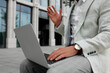 © New Africa - Businessman with laptop on city street, closeup