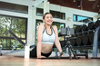 © Thanumporn - Young woman watching fitness video or having video conference with fitness trainer at smartphone screen.