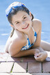 © Designpics - Girl by Swimming Pool