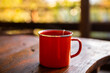 © Austockphoto - orange enamel cup in morning light