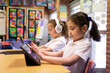 © Austockphoto - Two Young Schoolgirls on iPads in Classroom