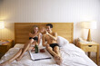 © Designpics - Couple in Bed With Food and Champagne