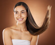 Hair, beauty and skincare with a model woman in studio on a brown background for natural or keratin treatment. Face, haircare and salon with an attractive young female posing to promote a product