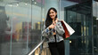 © Prathankarnpap - Portrait of fashionable women with shopping bags in hands standing in the shopping district of a city