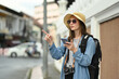 © Prathankarnpap - Happy caucasian female traveler with backpack on holiday vacation trip in Thailand. Blogger, vacation and journey concept