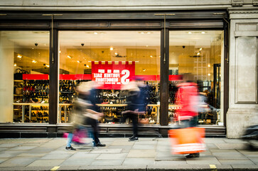 Canvas Print - Motion blurred shoppers on busy street
