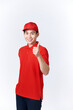 © makistock - Professional delivery guy employee man in red cap T-shirt uniform workwear work as dealer courier showing thumb up like gesture isolated