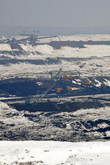 Wall Mural - A huge excavator on a surface coal mine in winter conditions. Interesting appearance of surface mining under snow.