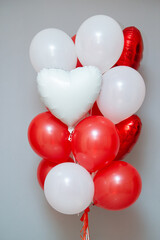 Wall Mural - red and white balloons on the background of the wall, a set of red balloons. Inscriptions on foil hearts: 