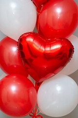 Wall Mural - red and white balloons on the background of the wall, a set of red balloons. Inscriptions on foil hearts: 